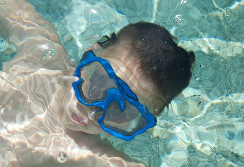 What are the benefits of swim goggles with a nose cover